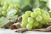 Green grapes on cloth and table Adobe Stock