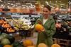 Woman scanning melon supermarlet Adobe stock