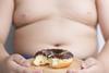 obese child with doughnut