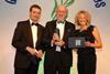 Tim Mudge, centre, accepts the award