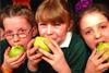 Schoolkids eating apples