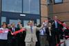 John Hayes, MP for South Holland and The Deepings, cuts the red ribbon to officially open the Apple Way site