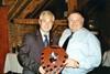 Clive Edmed (r) is presented with the Tesco shield by Martin de la Fuente
