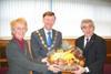 Culverwell, right, presents the mayor and his wife with a basket of fruit