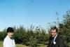 The minister plants a Gala tree with Balicki