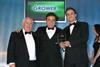 Tony Reynolds, centre, with dad Dave, left, accepting the Re:fresh Food Service Supplier of the Year award last month