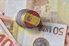 Euro coin and notes with Spanish flag