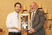 Gonzalo Avila, left, receives his award from Lance Jungmeyer