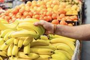 Picking up bananas in supermarket Adobe Stock
