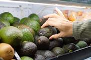 Shopper buying avocado Adobe Stock
