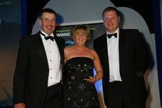 Clive and Debbie Wareing collect the award from Simon Martin, director of QV Fresh Approach