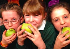 Schoolkids eating apples