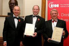 Paul Foley, left, presented Frazer Thompson, managing director of the English Wines Group, and Nick Marston, right, with their awards at the CIM FDA annual dinner