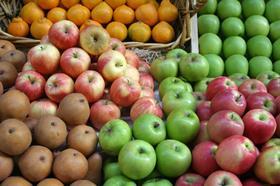 GEN Shutterstock_ Stacks of pears, apples, and oranges on display at a farmers market