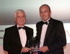 David Hurley, Anglia’s managing director, left, receives the award from category sponsors MITEL