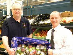John Worth with Tesco duty manager Matt Walters taking delivery of the first crate of the 2009 season
