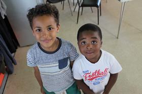 Two boys from a FareShare Charity Member waiting to be fed with food provided by FareShare