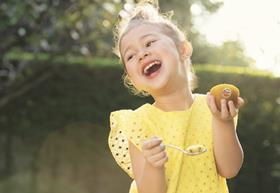 Girl enjoying Zespri Kiwifruit