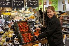 Christine Morgan, assistant store manager at Budgens Moreton in Marsh, puts the first English tomatoes of 2012 on shelf