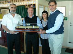 Captain Pejovic of the MSC Laura and Mike Economou, MSC director Cape Town, present a model of the MSC Laura to Capespan Exports’ Penny Thebus and Deon Joubert