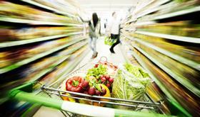 GEN trolley full of fresh produce in supermarket alley