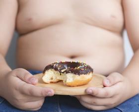 obese child with doughnut
