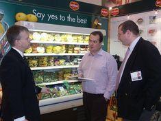 Chris Tune, left, and Nick Douglas, Del Monte's general manager at Methwold, right, discuss the company's new range with a potential customer at Food & Drink Expo.