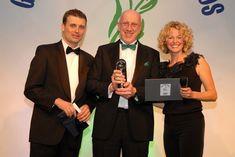 Tim Mudge, centre, accepts the award