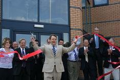 John Hayes, MP for South Holland and The Deepings, cuts the red ribbon to officially open the Apple Way site