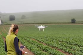 Catriona McLean with drone at SeedSPot farm lo res