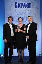 Margie Ribton collecting her award from MorePeople director Guy Moreton and BBC TV sports presenter John Inverdale.