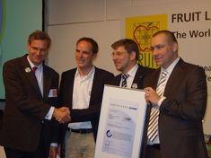 Eosta ceo Volkert Engelsman, far left, receives the certification from the TÜV Nord and Soil & More team