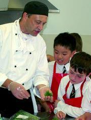 ARAMARK chef Steve Coupe making Shepherd's Pie with boys from Nottingham High Junior School during British Food Fortnight 2006