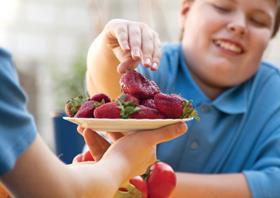 fat kid eating fruit