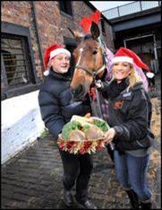 Dennis Hutchinson, md of JR Holland and Susan Tron from Stepney Banks Stables saddle up for Santa