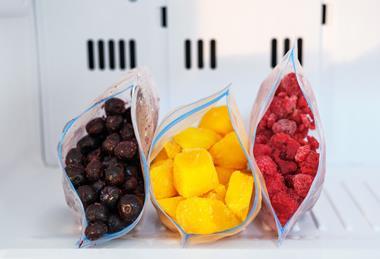 Frozen blueberries, mangoes and raspberries in a freezer