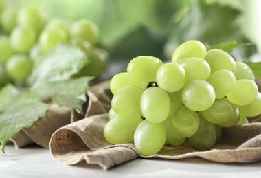 Green grapes on cloth and table Adobe Stock