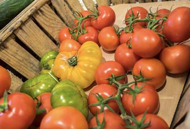 Mixed tomatoes in wooden container