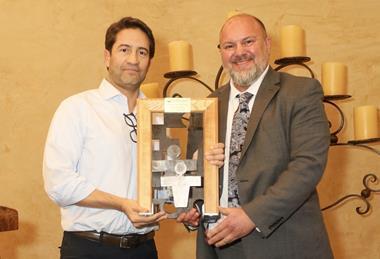 Gonzalo Avila, left, receives his award from Lance Jungmeyer