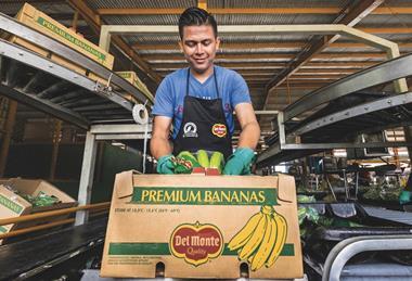 Fresh Del Monte worker packing box