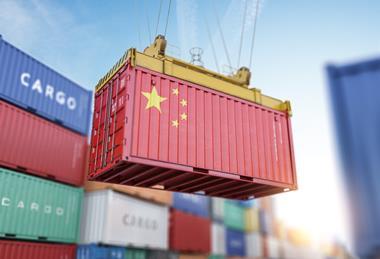 Container painted in Chinese flag being moved by crane