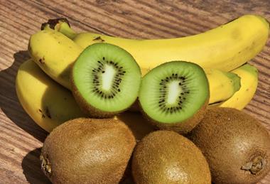 Kiwifruit and bananas on wooden board Adobe Stock