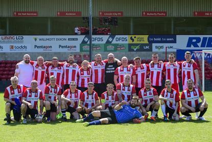 Simon Telfer, HR  director, with the staff football team from the Branston office and fresh factory at the Lincoln site