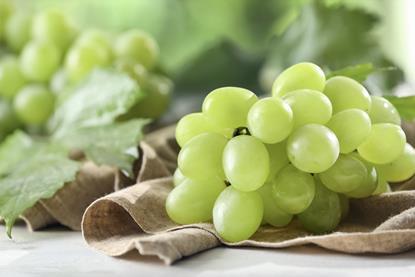 Green grapes on cloth and table Adobe Stock