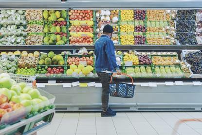 Supermarket shopper browsing fresh produce Adobe Stock