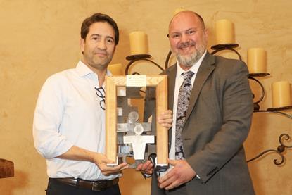 Gonzalo Avila, left, receives his award from Lance Jungmeyer