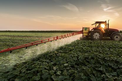 Tractor spraying vegetables