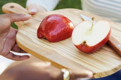 Envy apples on wooden board sliced Oppy