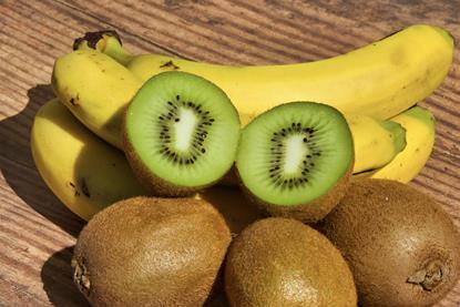 Kiwifruit and bananas on wooden board Adobe Stock