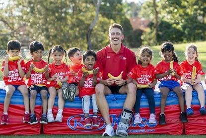 Brandon Starc with Tiny Tots for the Coles Banana A-Peel launch